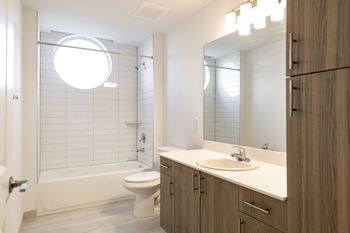 a bathroom with a sink and a toilet and a shower