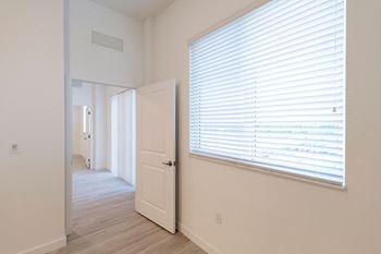 a large window and a door in a room with a door open