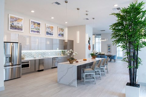 a kitchen with a long counter and a table with chairs