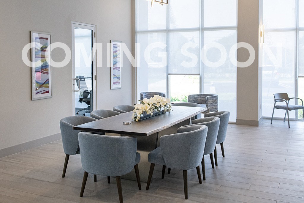 a conference room with a long table and chairs