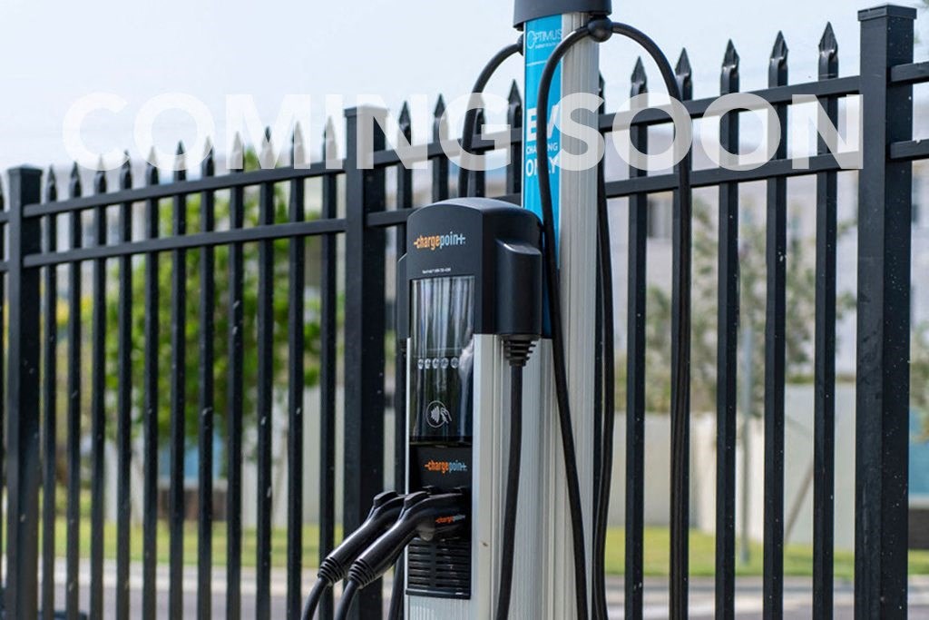 a charging point in front of a fence with a fence