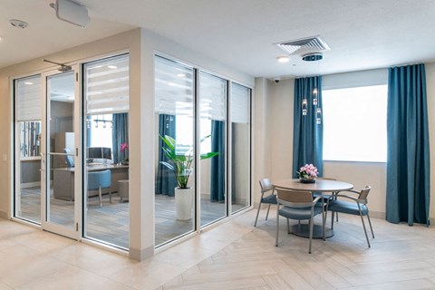 a dining room with glass doors and a table and chairs