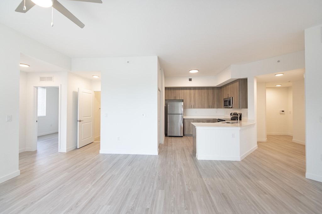 A spacious kitchen with a refrigerator, microwave, and oven.