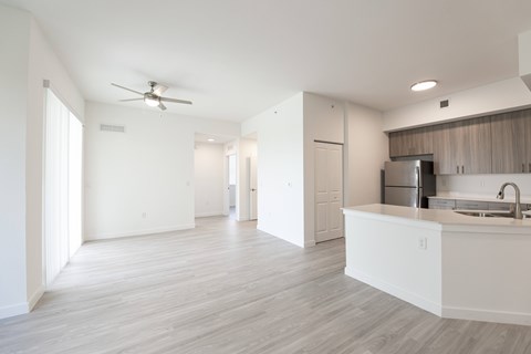 A spacious kitchen with a white countertop and a ceiling fan.