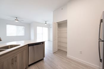 A kitchen with a refrigerator, sink, and dishwasher.