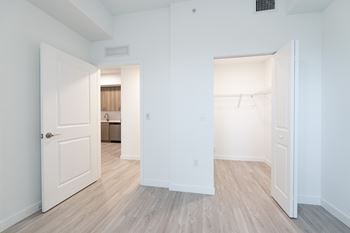 A white room with two open doors.