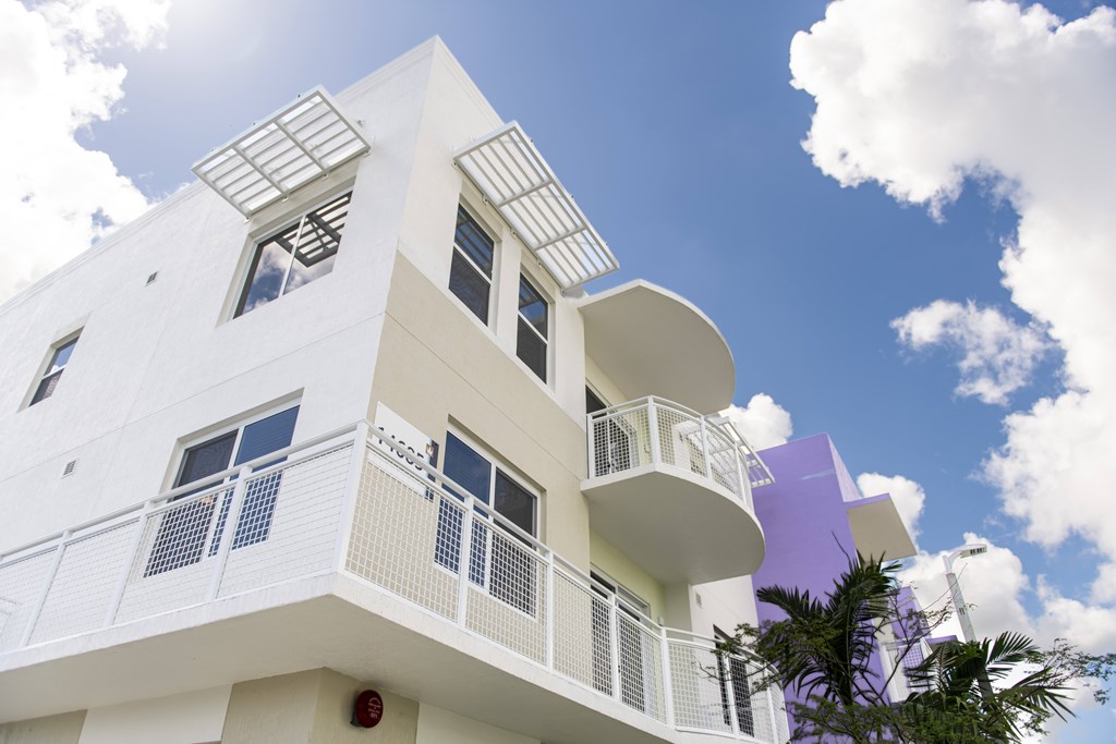 A white building with a purple section on the side.