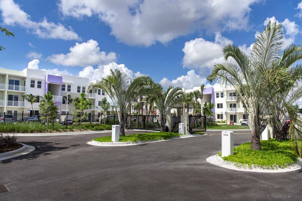 A sunny day at a residential complex with a paved courtyard.