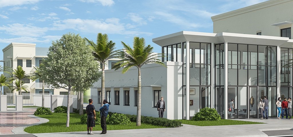 A white building with large windows and people standing outside.