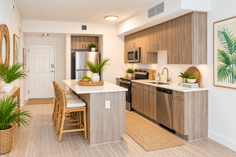 A kitchen with a table and chairs and a fridge.