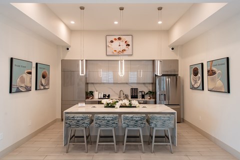 A modern kitchen with a dining table and chairs.
