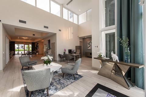A modern living room with a dining table and chairs.