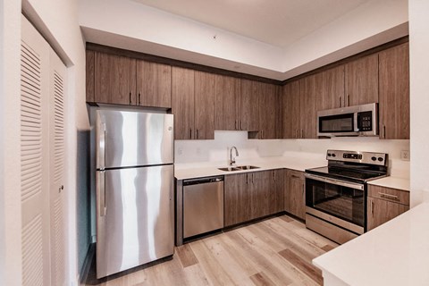 a kitchen with stainless steel appliances and wooden cabinets