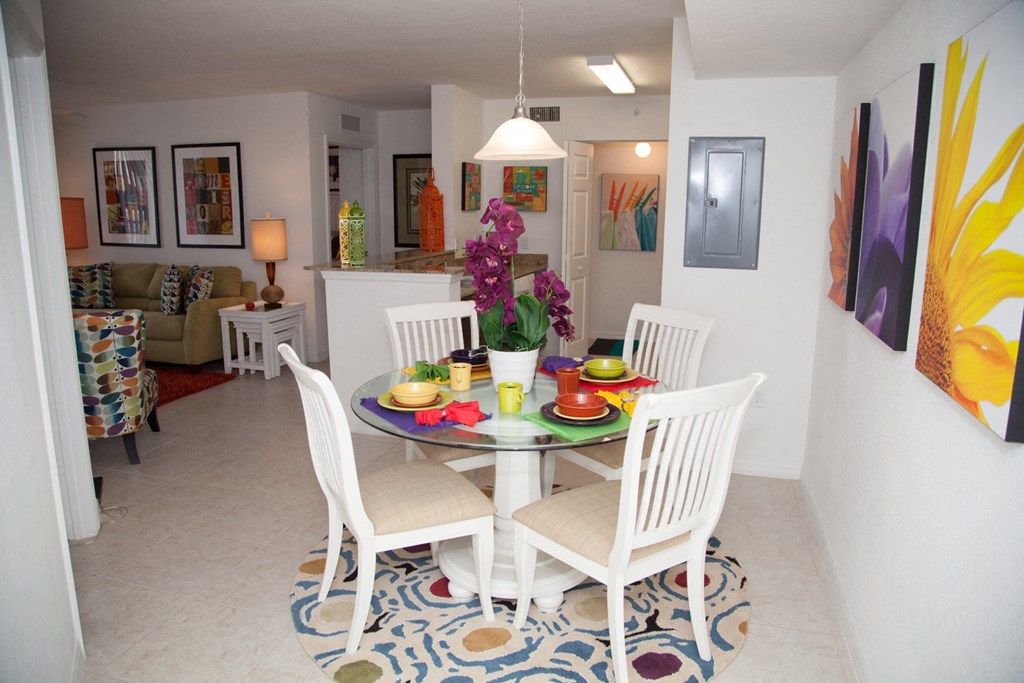 a dining room and living room with a table and chairs