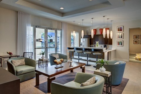 A living room with a green chair and a brown coffee table.