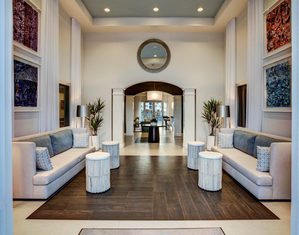 a lobby with couches and round tables