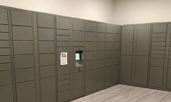 A row of grey lockers in a room.