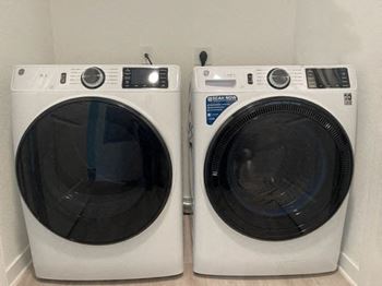 two washing machines are sitting next to each other