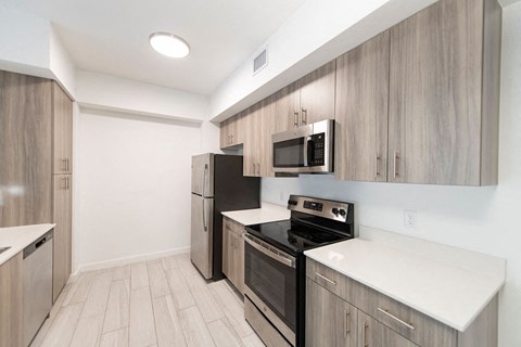 a kitchen with wooden cabinets and stainless steel appliances
