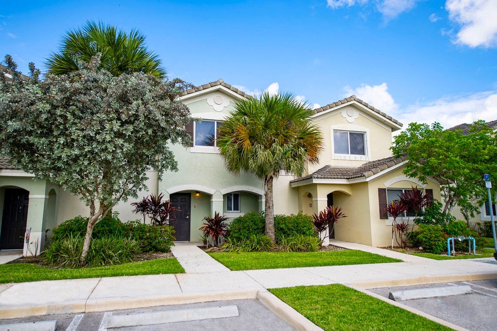 a white house with palm trees in front of it