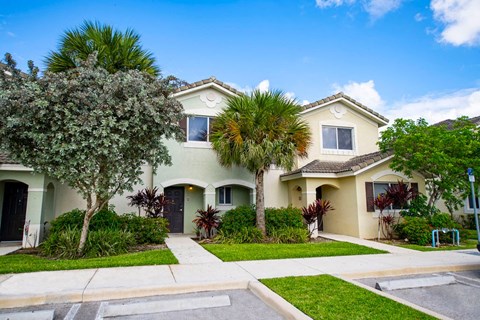a white house with palm trees in front of it