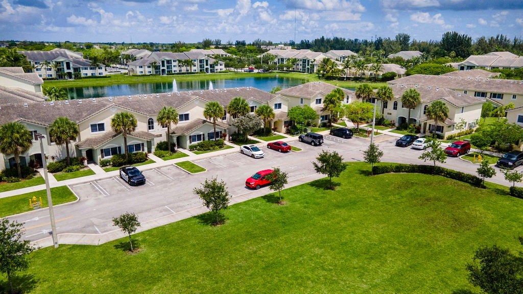 an aerial view of a community with cars parked in a parking lot