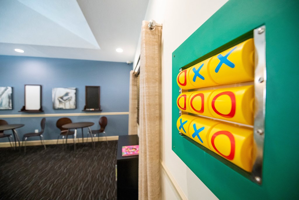 a room with a green wall with yellow rolls of paper on it