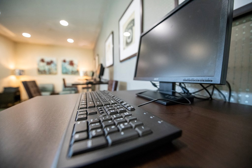 a computer keyboard sitting on top of a wooden desk