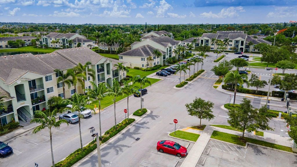an aerial view of a neighborhood of houses with cars parked in a parking lot