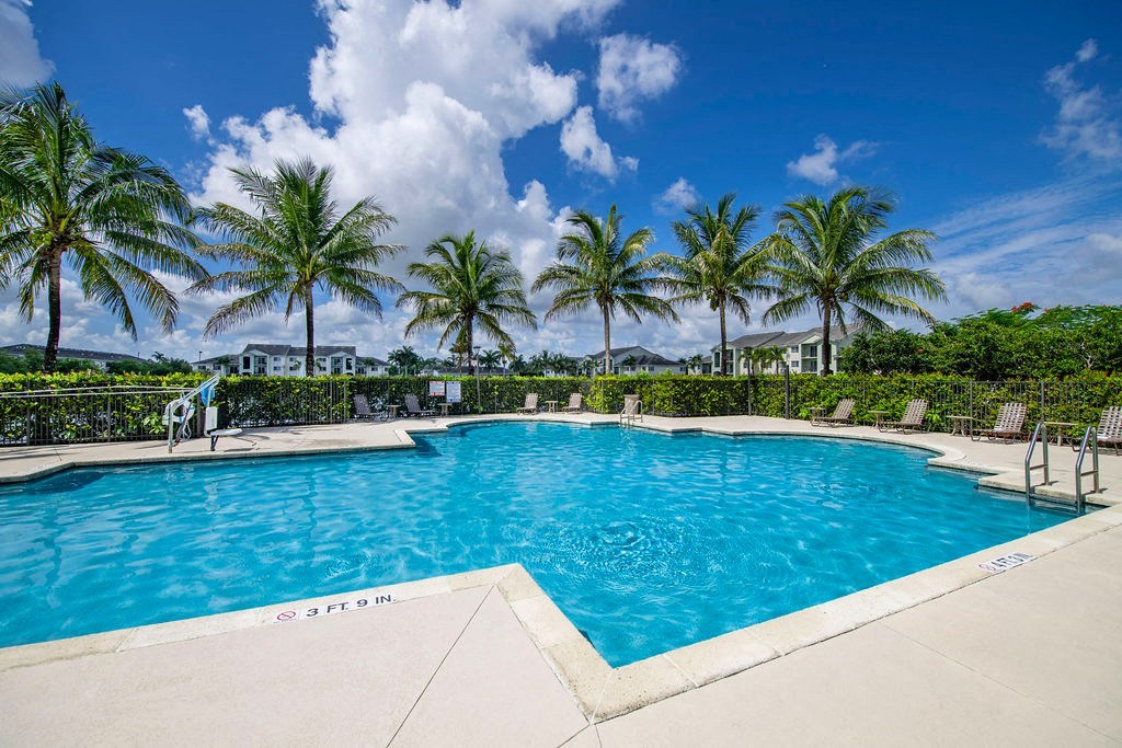 a swimming pool at a resort with palm trees
