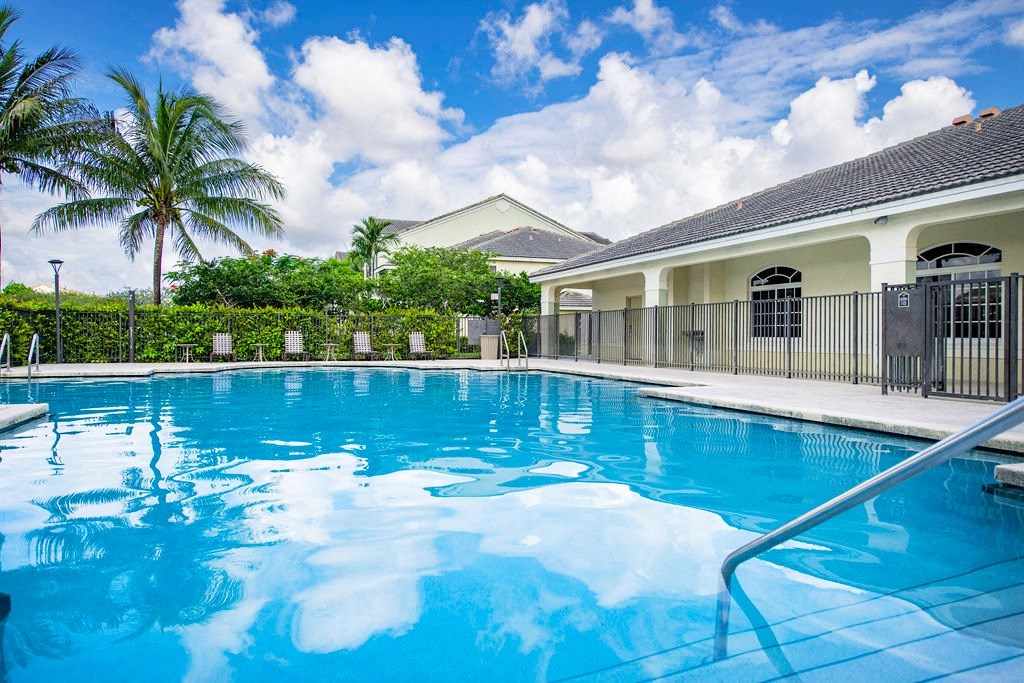 a large swimming pool in front of a house