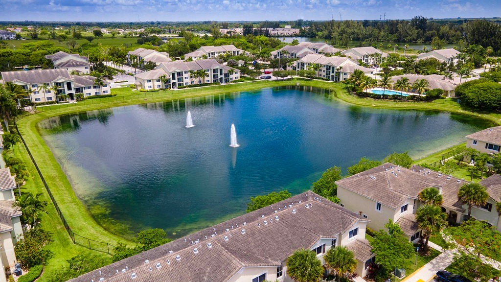 an aerial view of a lake with sailboats in the middle of the community