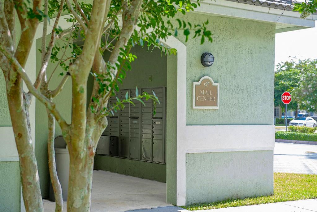 a building with a stop sign and a tree