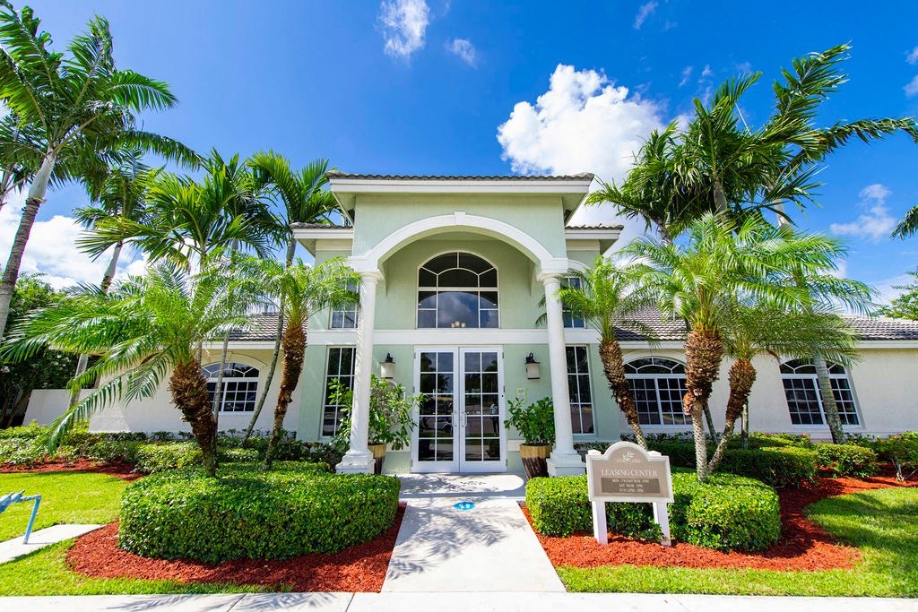 a home with palm trees in front of it