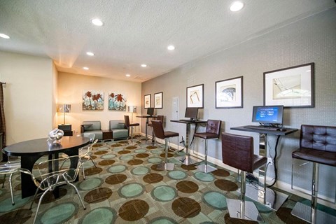 a conference room with tables and chairs and a computer