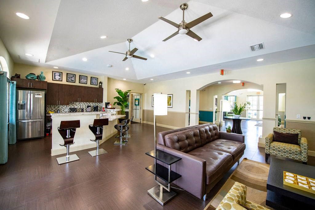 a living room with a couch and a kitchen