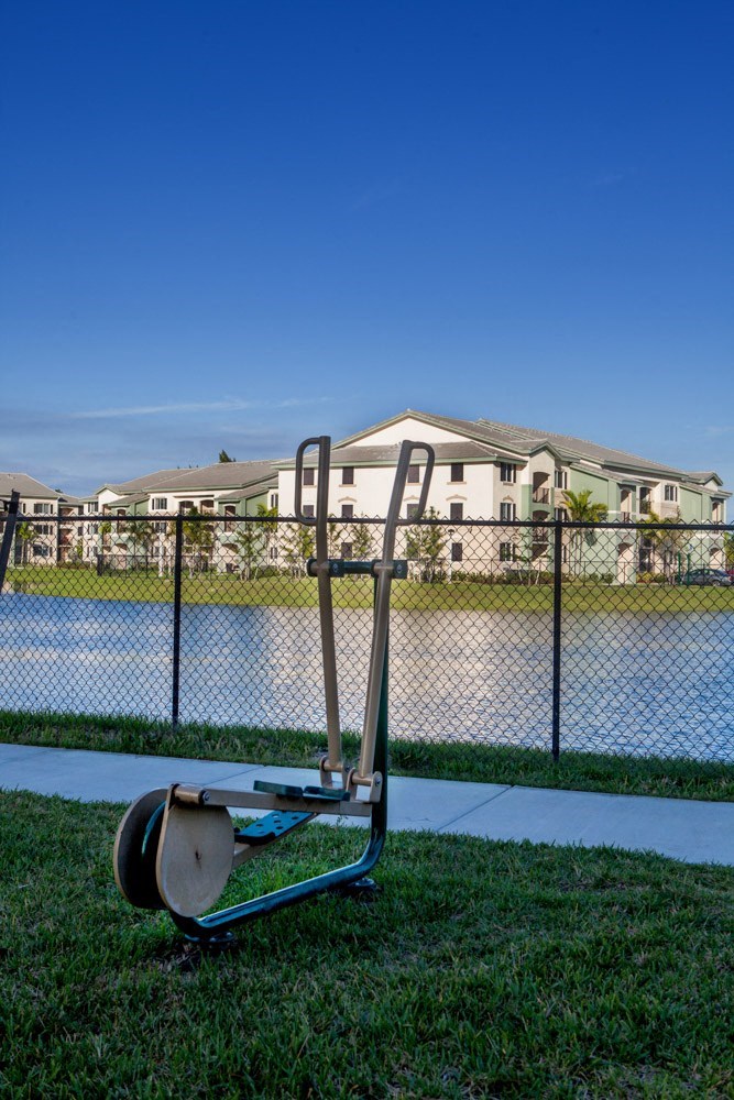 a mobility scooter parked in the grass next to a fence