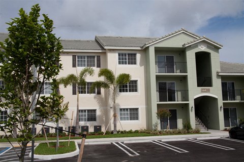 a large building with palm trees in front of it