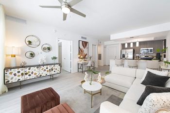 a living room with furniture and a ceiling fan