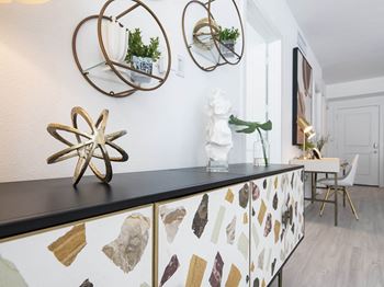 a kitchen with a counter top and several mirrors on the wall