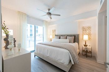 a bedroom with a bed and a ceiling fan