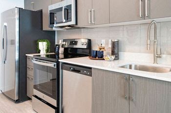 a kitchen with a sink and a stove and a refrigerator