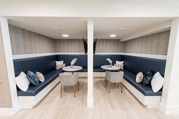 A modern living room with a blue couch and a wooden floor.