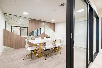 A conference room with a long table and chairs.