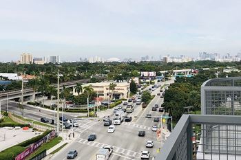 a busy city street with cars and buildings