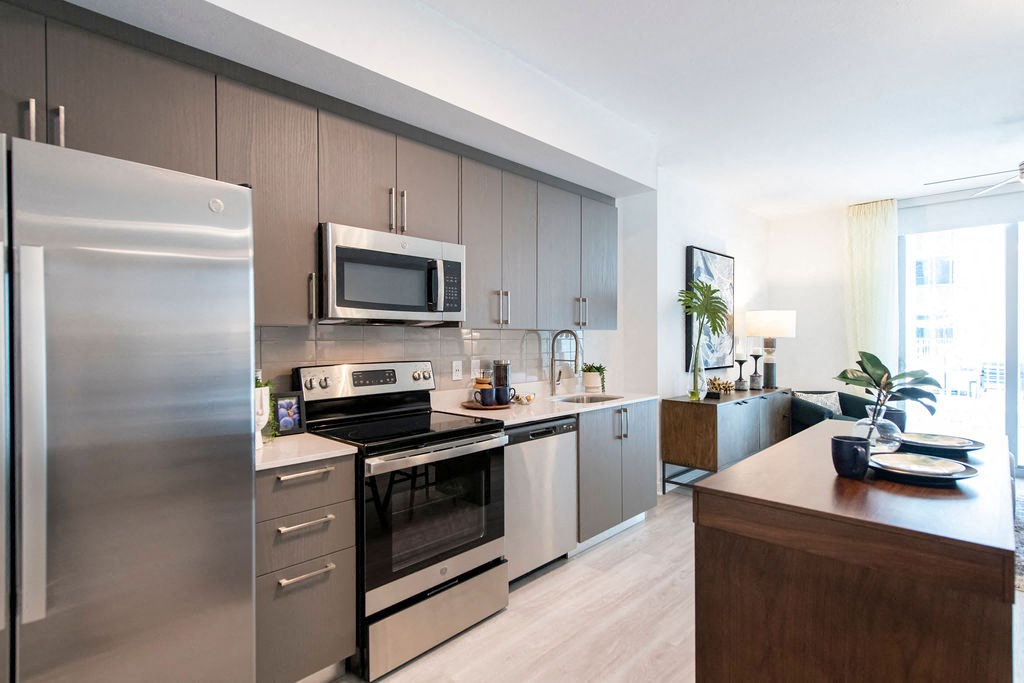 a kitchen with stainless steel appliances and a wooden counter top