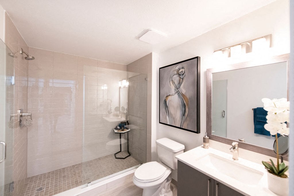 a bathroom with a shower toilet and sink