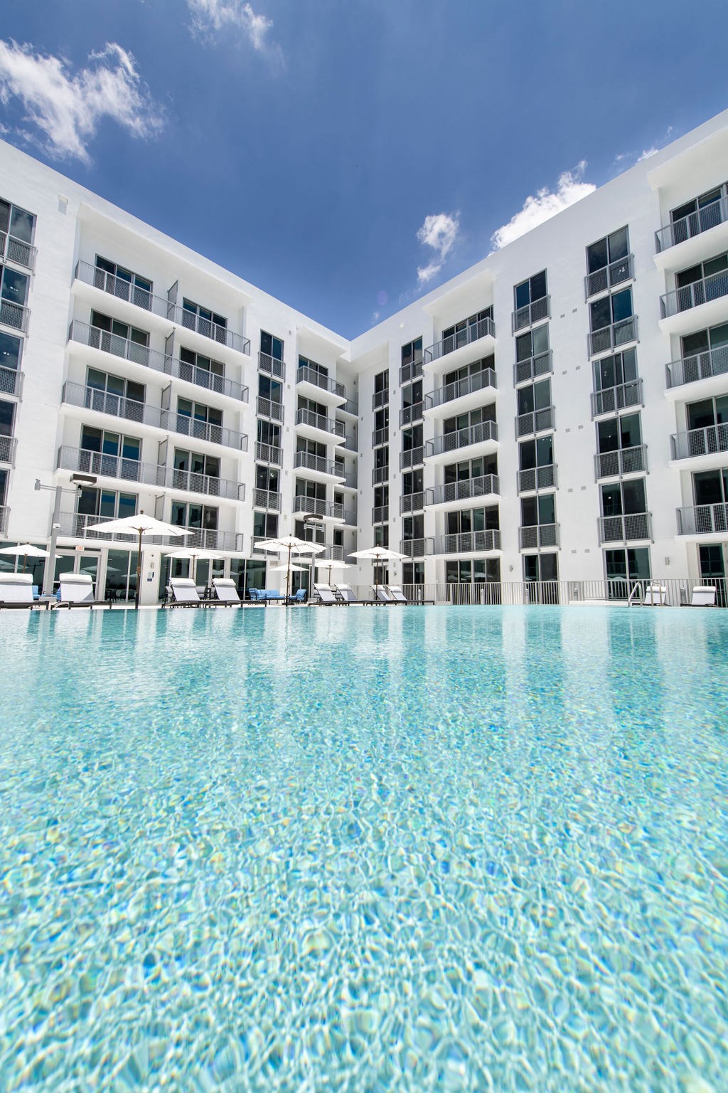 a swimming pool in front of an apartment building