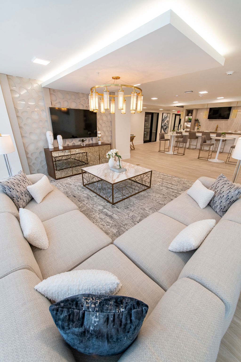 a living room filled with furniture and a large chandelier