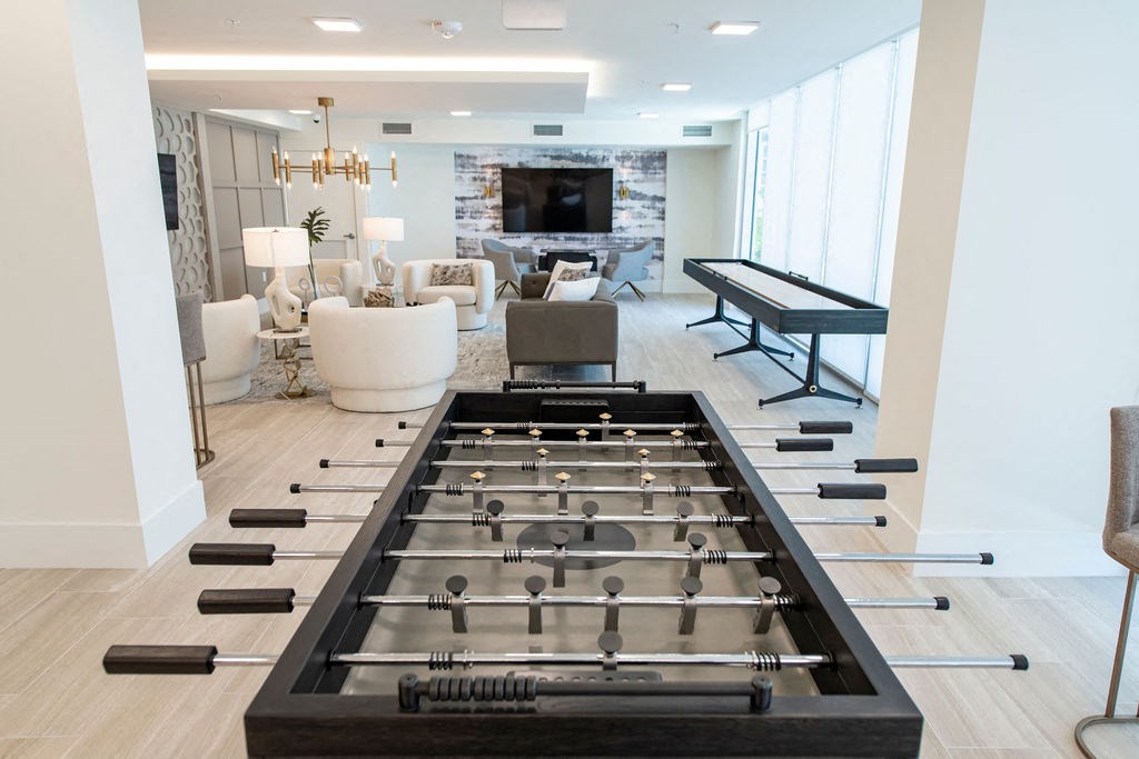 a game room with a foosball table and a ping pong table